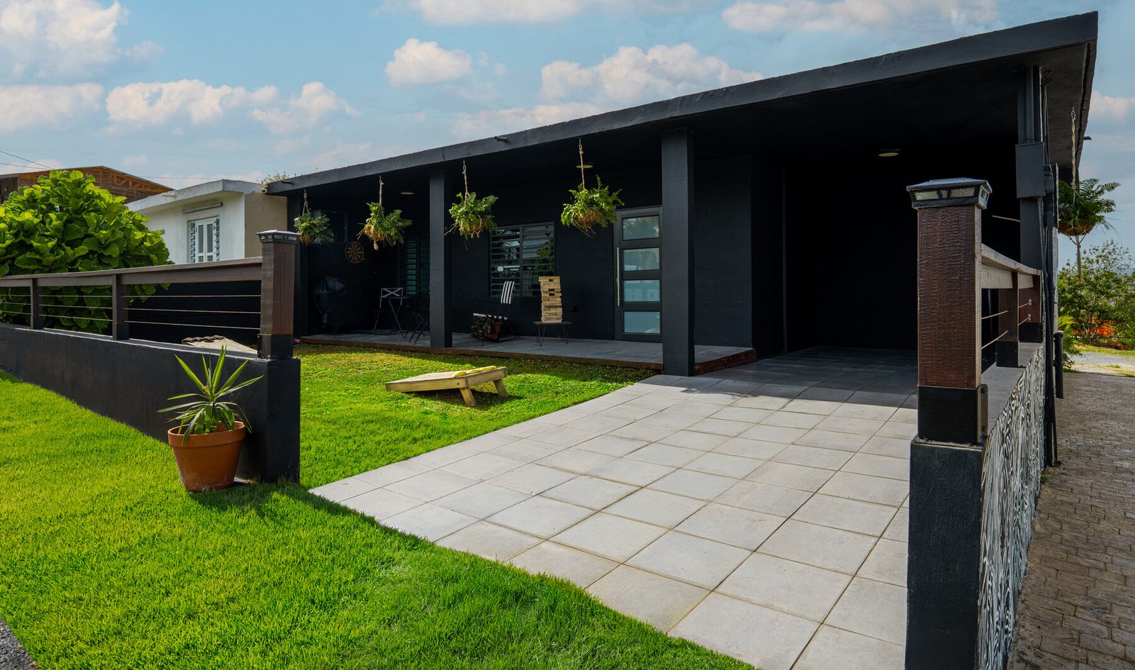 Casita Negra exterior with covered porch and lawn